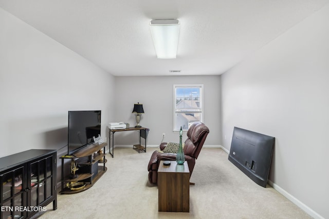 carpeted office with baseboards and visible vents