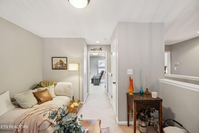 interior space featuring baseboards and light colored carpet