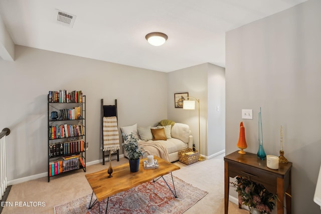 living area with carpet, visible vents, and baseboards