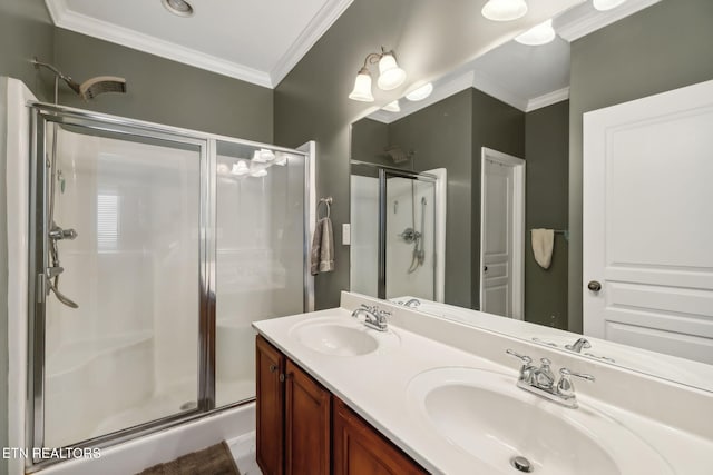 bathroom with a shower stall, ornamental molding, and a sink