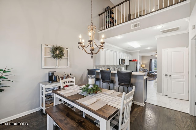 dining room featuring visible vents, baseboards, ornamental molding, and ceiling fan with notable chandelier