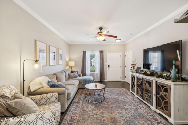 living area with baseboards, a ceiling fan, ornamental molding, and dark wood-style flooring