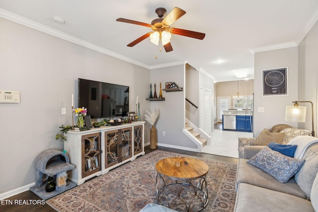 living room with stairs, wood finished floors, baseboards, and ornamental molding