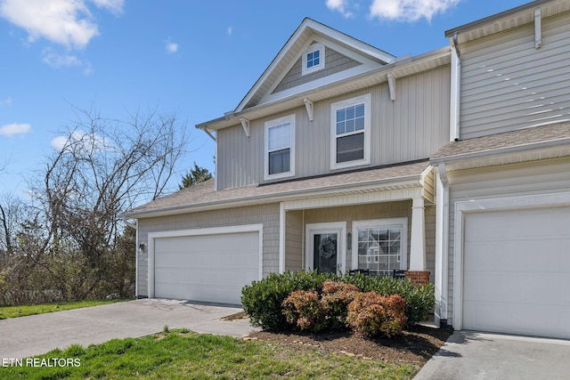 view of front of home featuring concrete driveway and a shingled roof