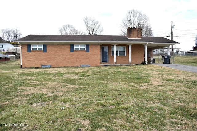 single story home with driveway, a chimney, an attached carport, fence, and brick siding