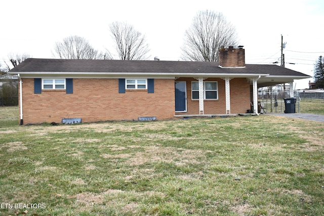 ranch-style house featuring an attached carport, a chimney, a front lawn, and brick siding