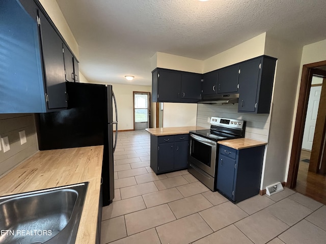 kitchen with light countertops, decorative backsplash, a sink, under cabinet range hood, and stainless steel electric range