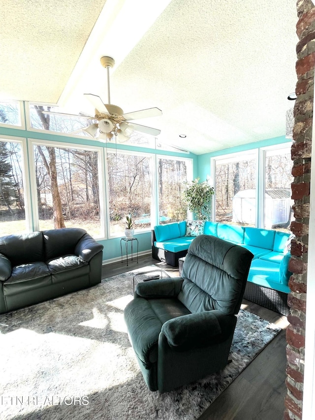 sunroom / solarium featuring ceiling fan and vaulted ceiling