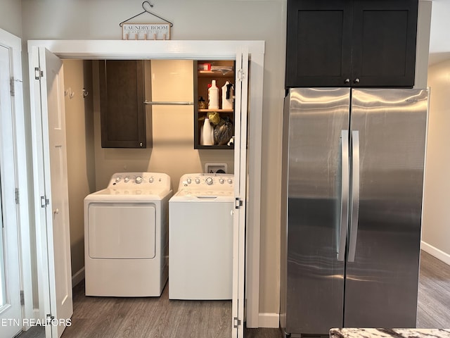 washroom with cabinet space, baseboards, wood finished floors, and independent washer and dryer