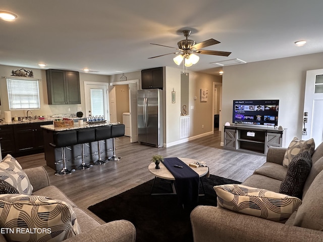 living room featuring baseboards, visible vents, and dark wood finished floors