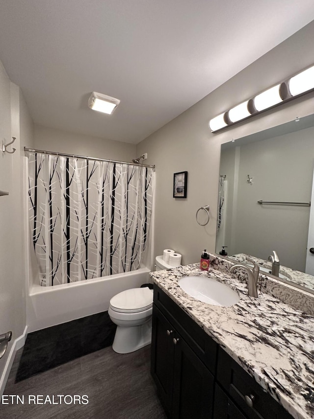 full bathroom with shower / bath combination with curtain, vanity, wood finished floors, and toilet