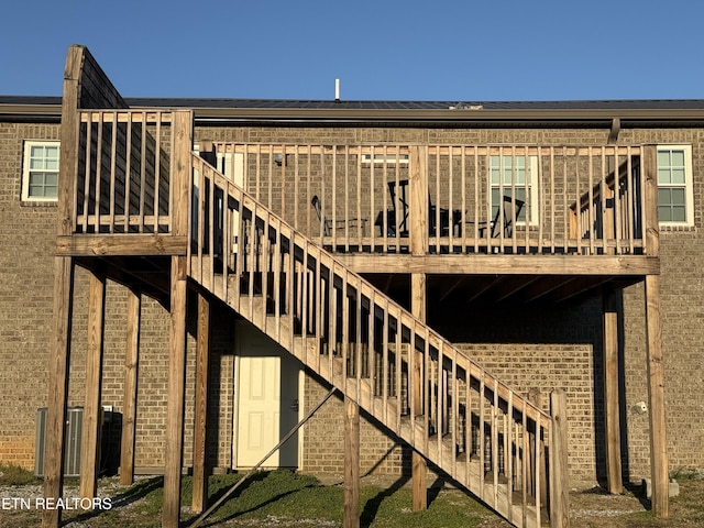 rear view of house featuring brick siding