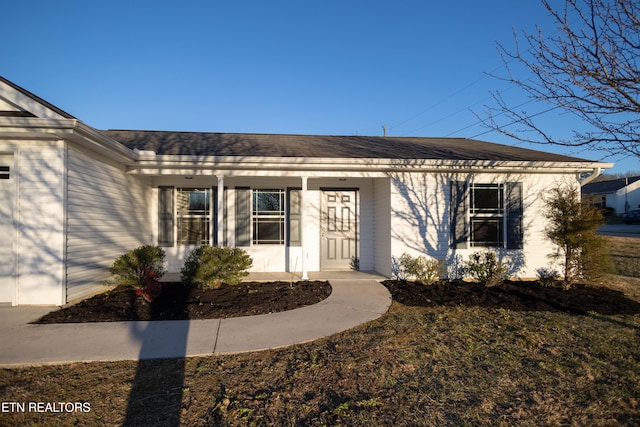 entrance to property with roof with shingles