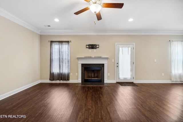 unfurnished living room featuring crown molding, dark wood finished floors, visible vents, a fireplace with flush hearth, and baseboards