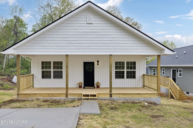 bungalow-style home with board and batten siding and covered porch