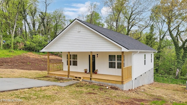 view of front of house featuring a shingled roof and covered porch