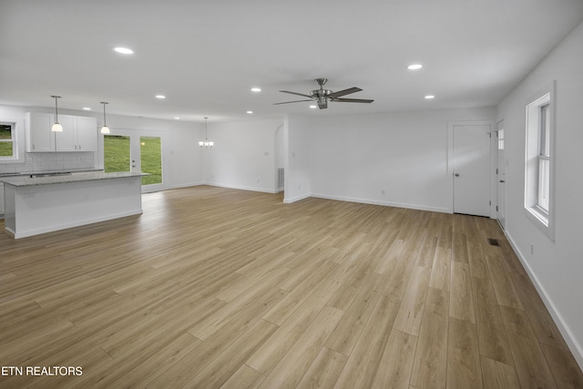 unfurnished living room with recessed lighting and light wood-style floors