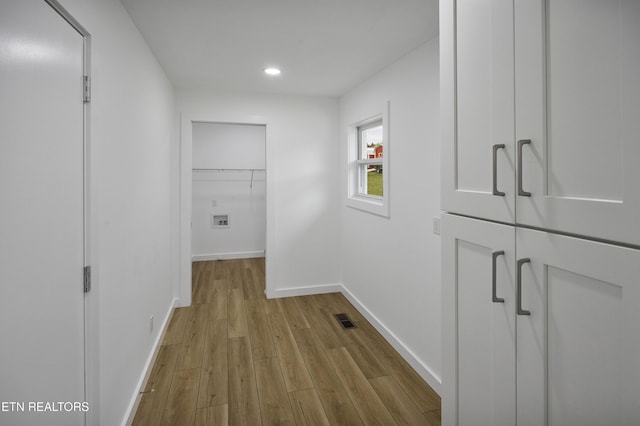 hallway featuring recessed lighting, visible vents, baseboards, and wood finished floors