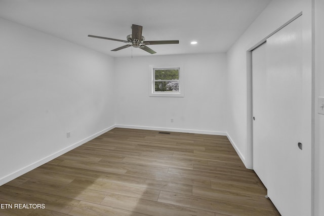 unfurnished bedroom featuring ceiling fan, recessed lighting, wood finished floors, and baseboards