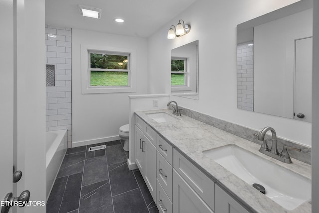 bathroom with toilet, a sink, visible vents, and baseboards