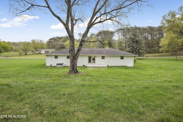 rear view of house with a patio and a lawn