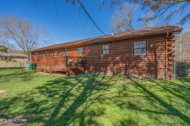 back of property with a yard, fence, and log siding