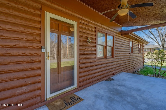 view of exterior entry with ceiling fan