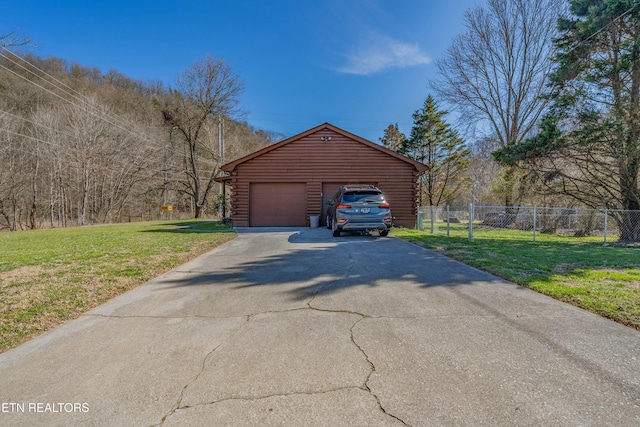 detached garage featuring fence