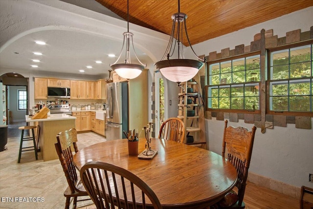 dining space featuring arched walkways, baseboards, a textured wall, wood ceiling, and recessed lighting