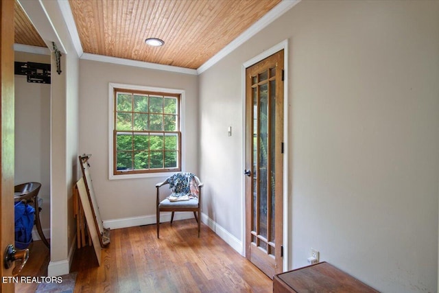 interior space with wooden ceiling, crown molding, baseboards, and wood finished floors