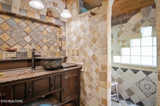 kitchen featuring dark brown cabinetry and a sink