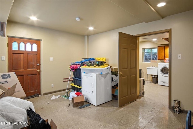 interior space with baseboards, washer / clothes dryer, a sink, and recessed lighting