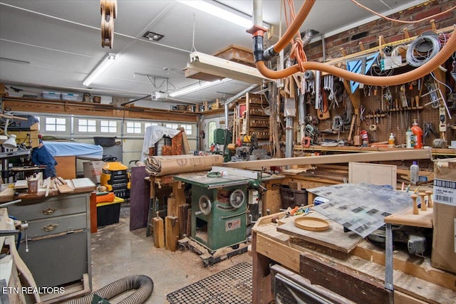 miscellaneous room featuring unfinished concrete flooring and a workshop area