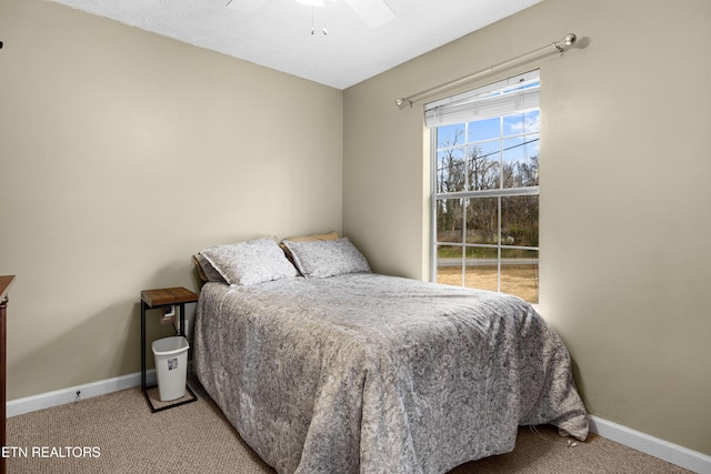 carpeted bedroom featuring ceiling fan and baseboards