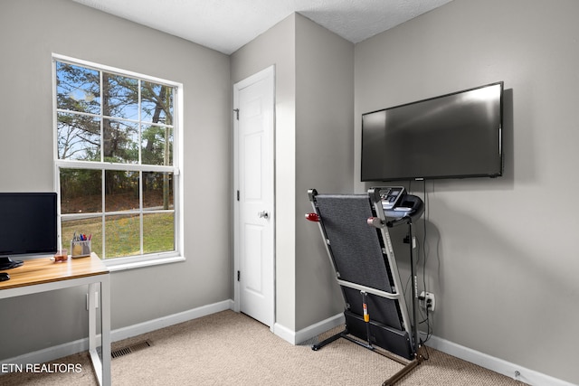 office space featuring carpet, visible vents, and baseboards