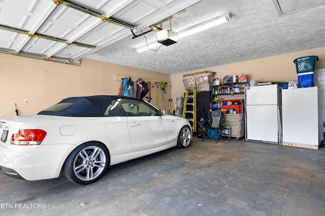 garage with freestanding refrigerator and a garage door opener