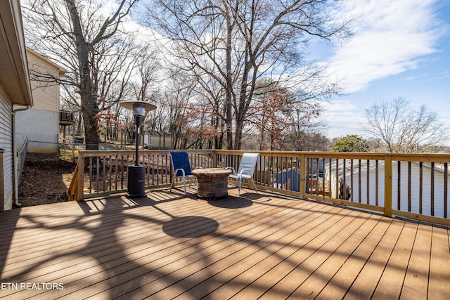 wooden terrace featuring fence