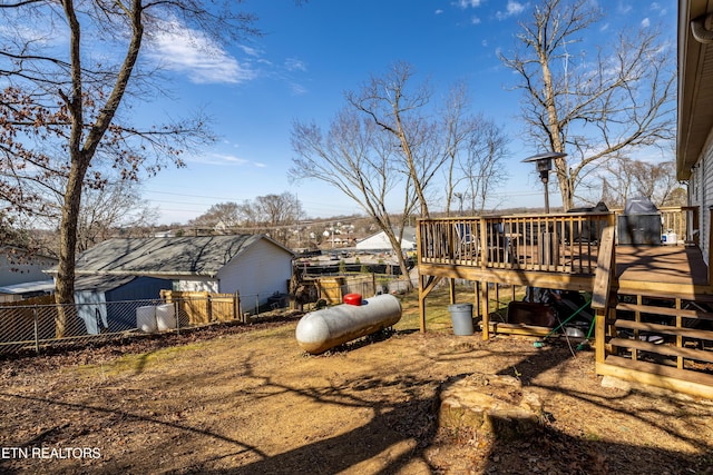 view of yard featuring fence and a wooden deck