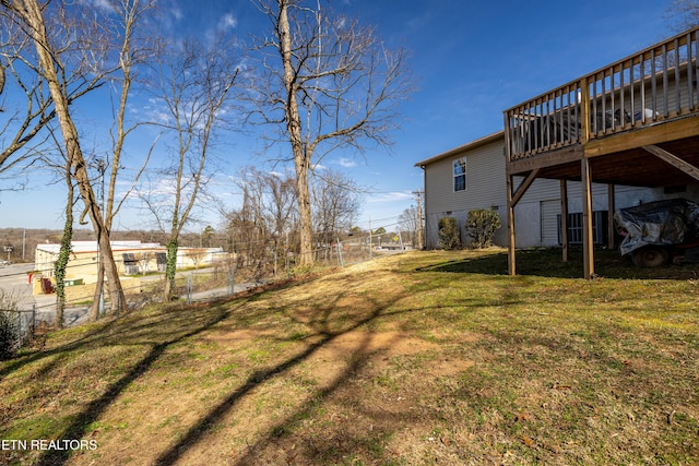 view of yard with fence and a deck