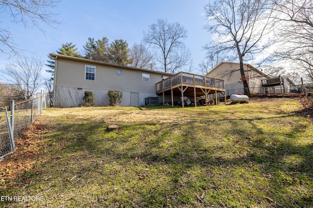 rear view of house featuring a yard, fence, central AC, and a wooden deck