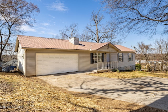 ranch-style home featuring crawl space, driveway, a chimney, and metal roof