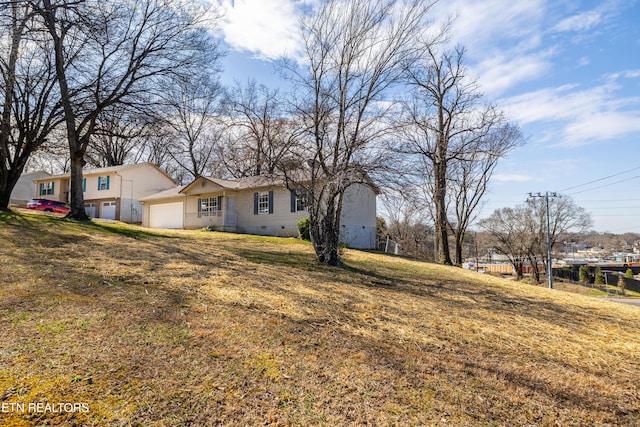 view of front of home with a front yard, crawl space, and an attached garage