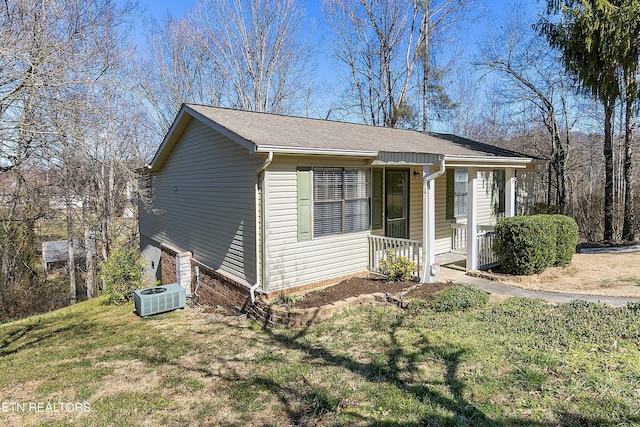 view of front of house with covered porch, a front lawn, and cooling unit