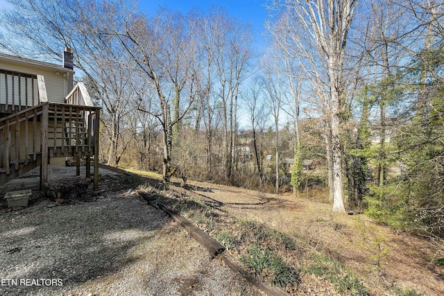 view of yard with a deck and stairway