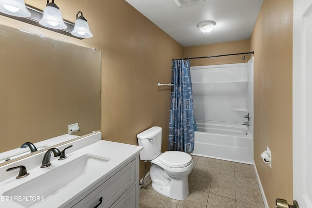 bathroom featuring toilet, shower / bath combo, vanity, baseboards, and tile patterned floors