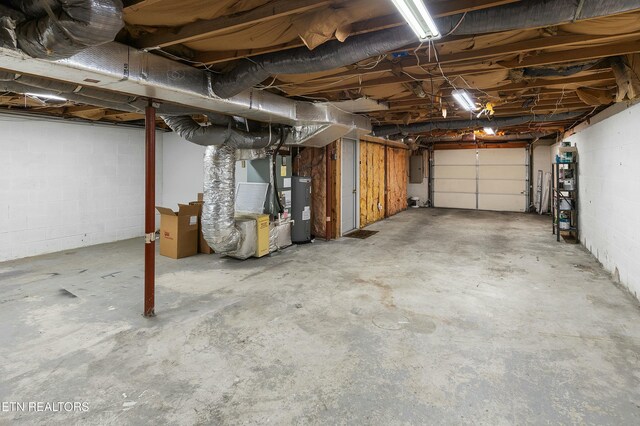 garage featuring electric panel and water heater