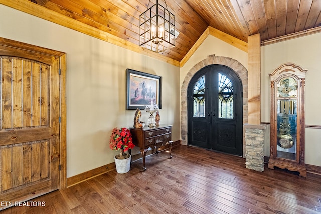 foyer entrance featuring arched walkways, hardwood / wood-style floors, wooden ceiling, and a notable chandelier