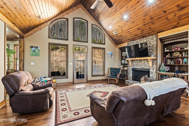 living area featuring wood ceiling, hardwood / wood-style floors, a stone fireplace, built in shelves, and high vaulted ceiling