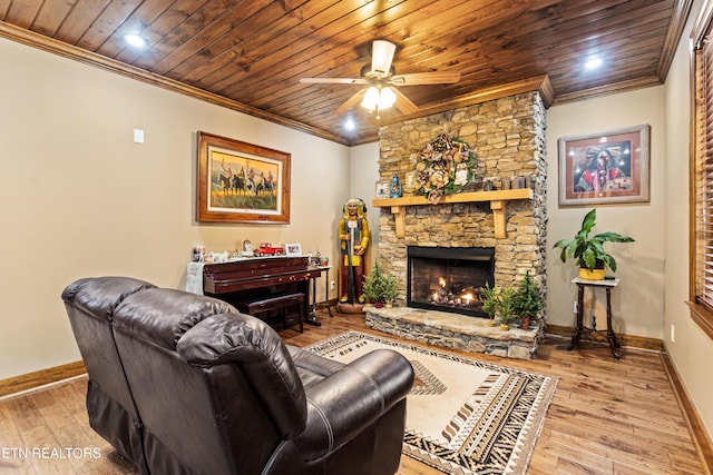 living room with baseboards, wood finished floors, wood ceiling, and crown molding