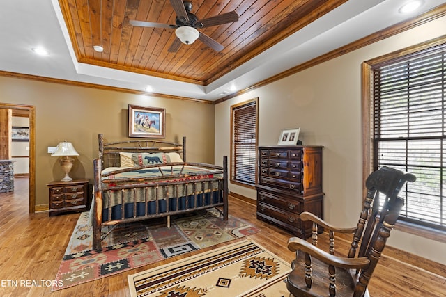 bedroom featuring a tray ceiling, wood ceiling, crown molding, and wood finished floors